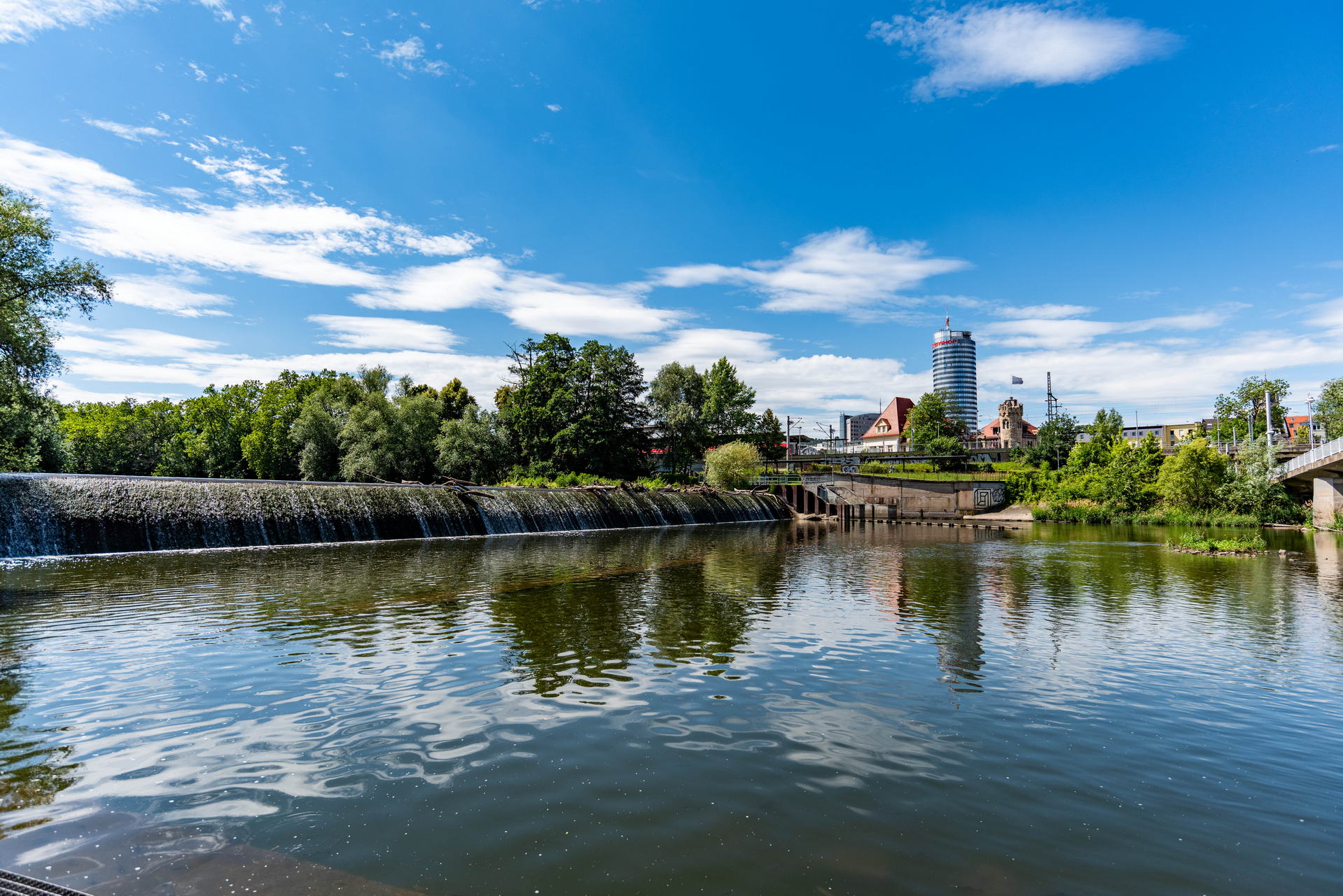 Saale Impressionen 6 Jenaer Saaleufer im Sommer mit Blick auf den Jentower im Jenaer Stadtzentrum.